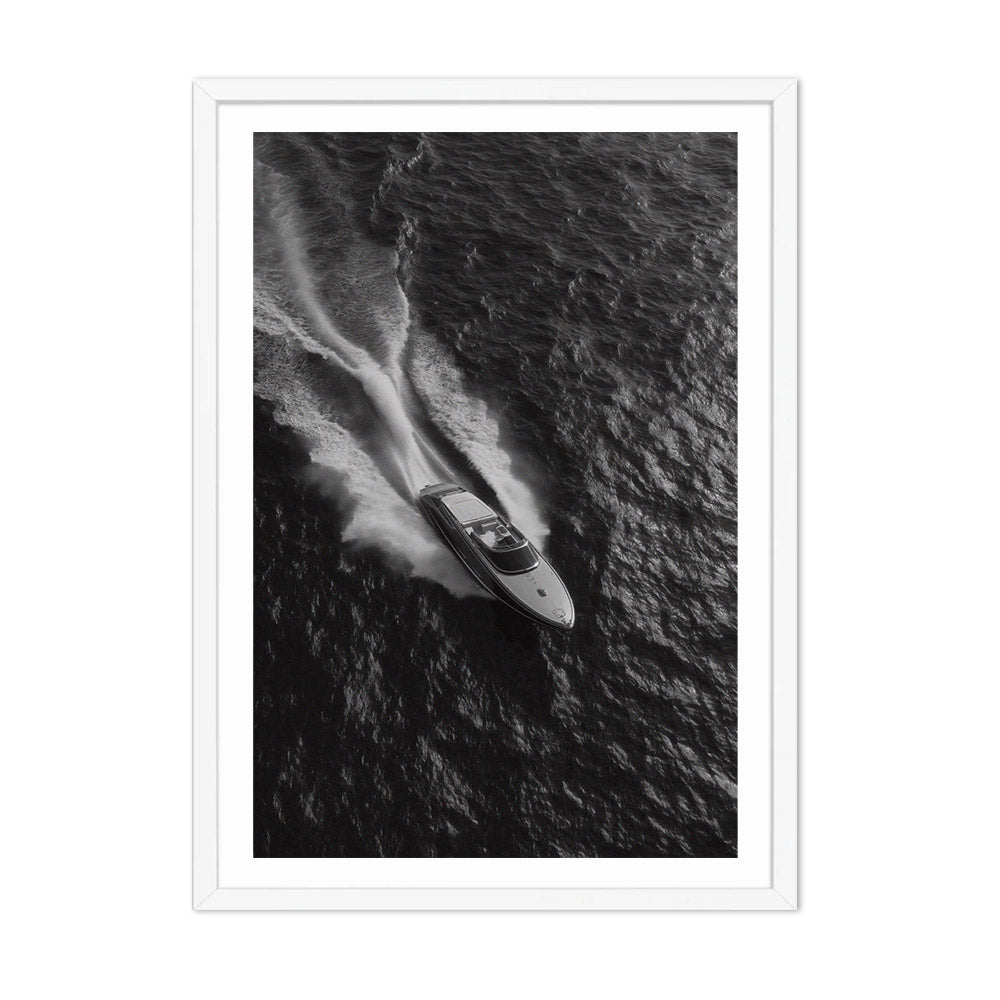 Black and white photograph of a speedboat on water with a white frame.
