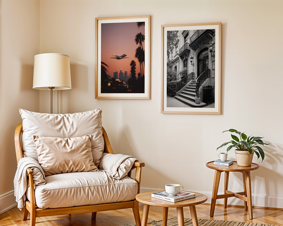 Living room with wooden armchair, side table, and framed artwork on the wall.