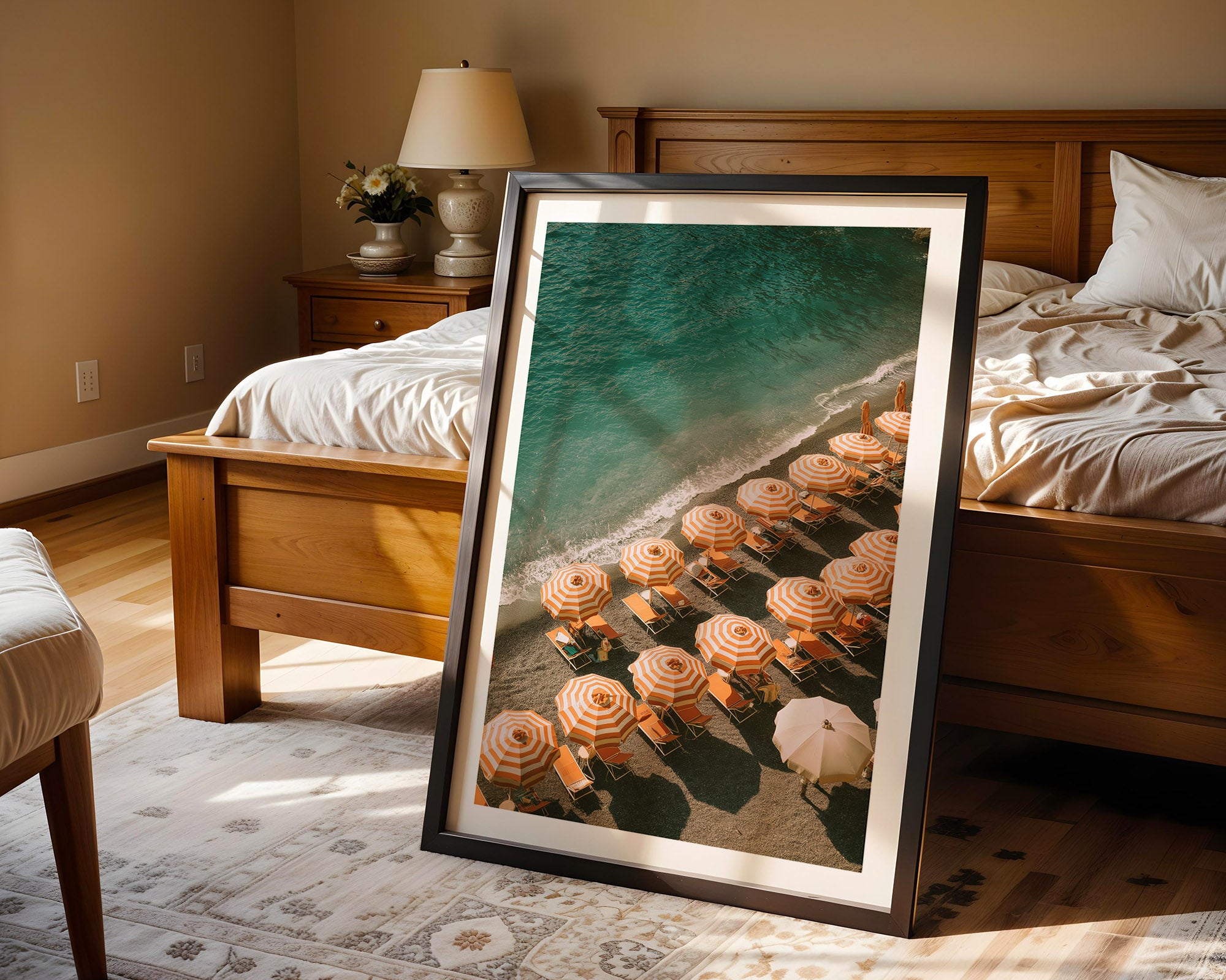 Framed artwork of a beach scene with flowers in a bedroom setting