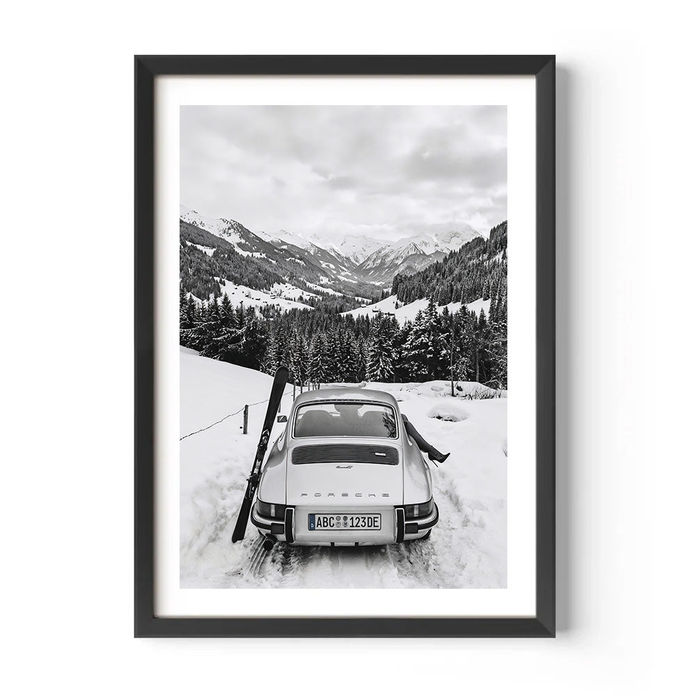 Framed black and white photograph of a vintage car in a snowy mountain landscape