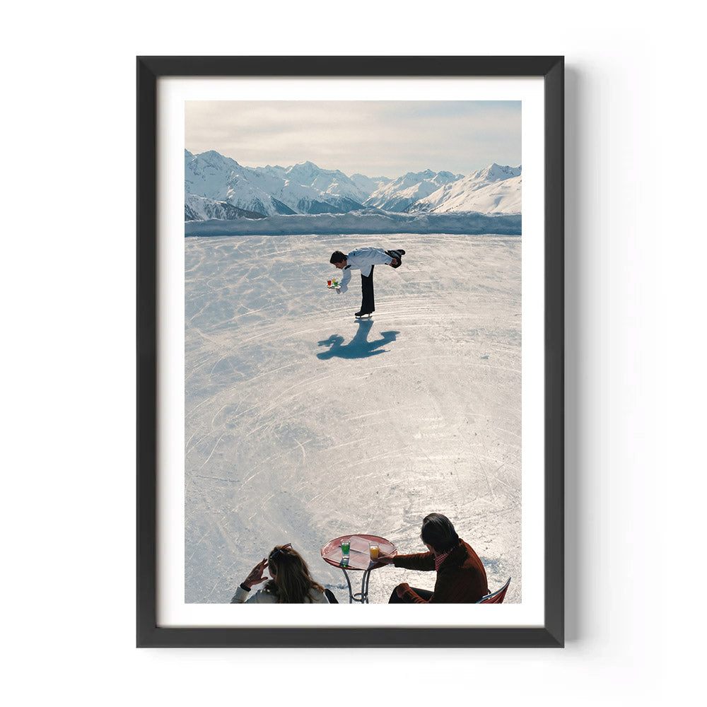 Framed photograph of a person standing on a frozen lake with mountains in the background
