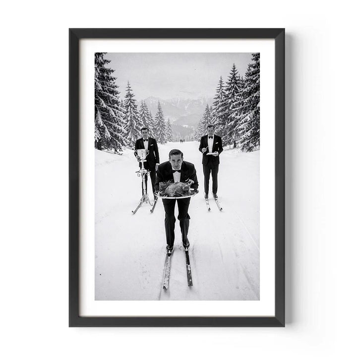 Framed black and white photograph of three people on skis in a snowy forest.