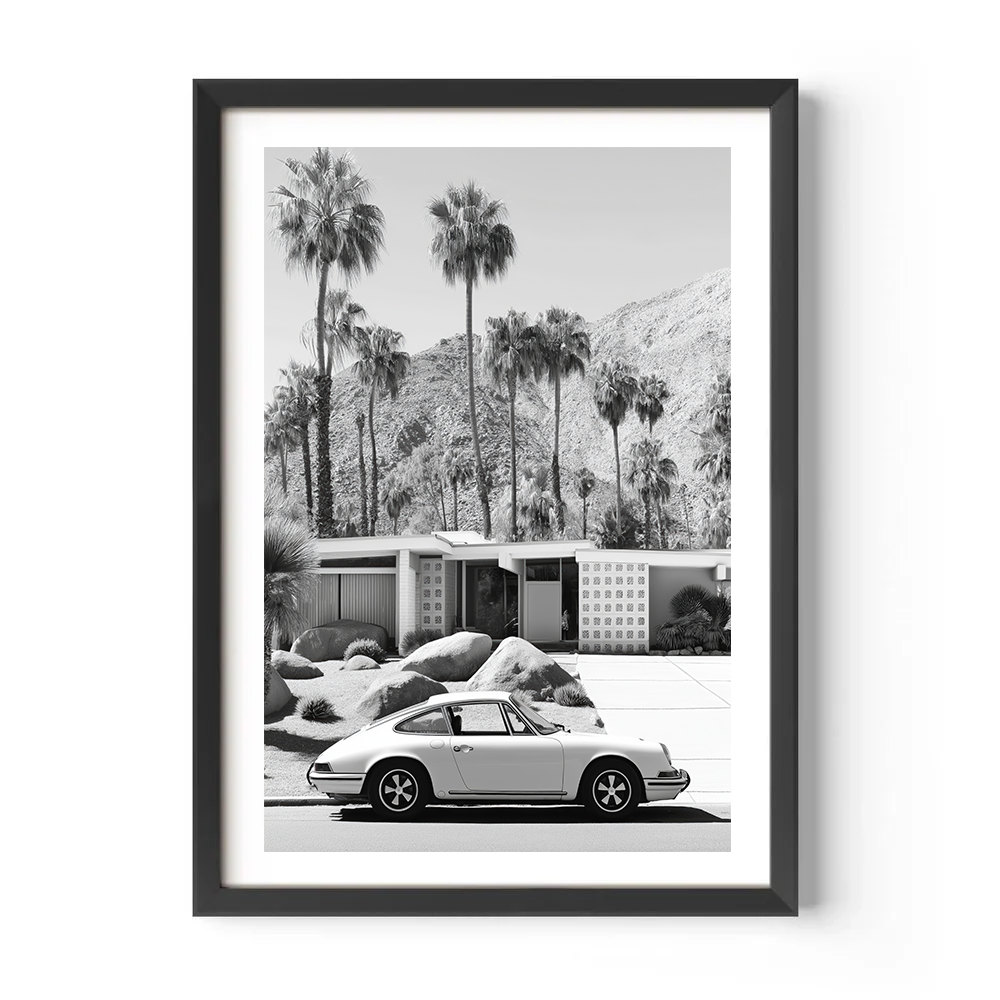 Framed black and white print of a Porsche car parked in front of a mid-century modern house with palm trees.