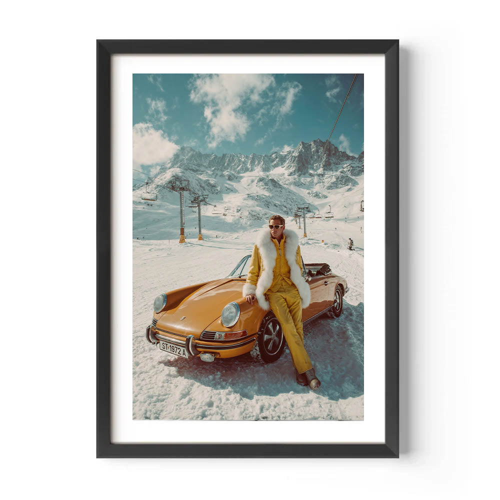 Framed artwork of a person in a yellow outfit sitting on a vintage car in a snowy mountain landscape.