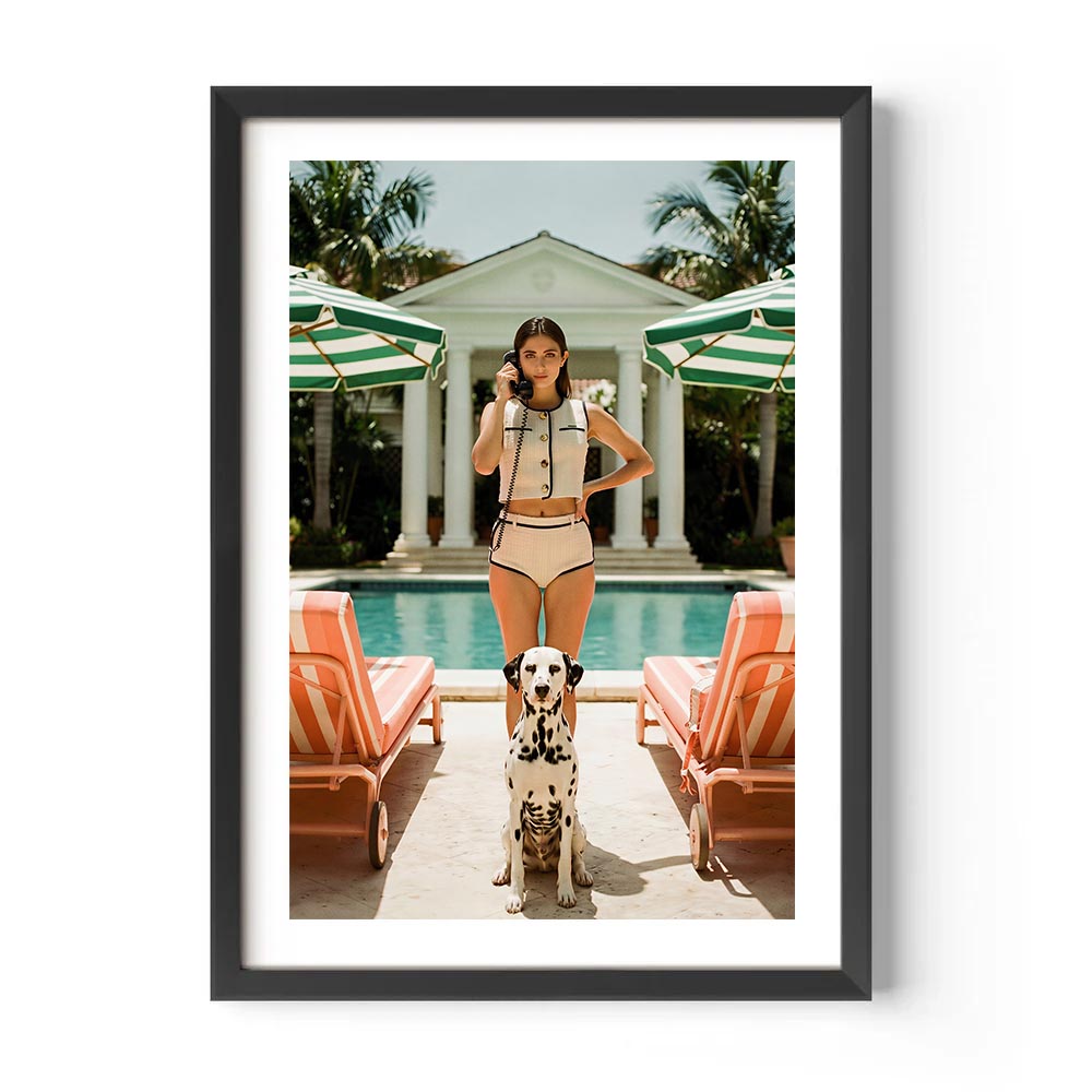 Framed photo of a woman in a swimsuit with a dog by a poolside.