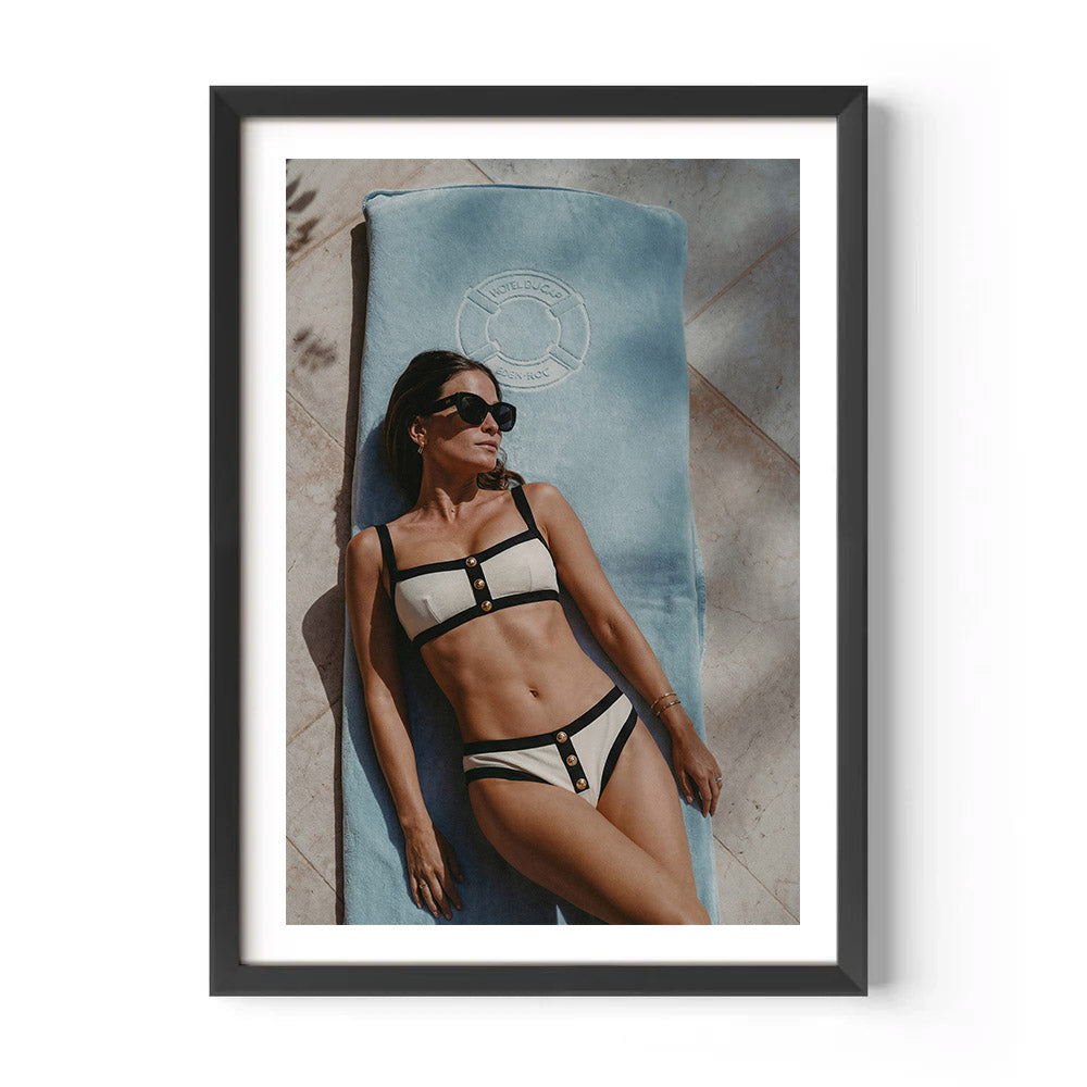 Framed photo of a woman in a bikini lying on a towel at Hotel du Cap-Eden-Roc