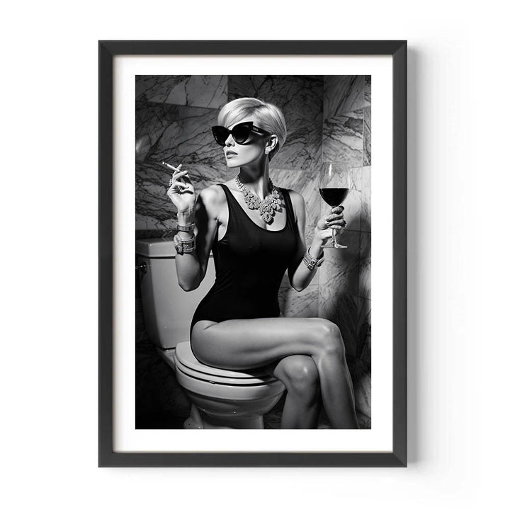 Framed black and white art print of a woman sitting on a toilet with a glass of wine and a cigarette.