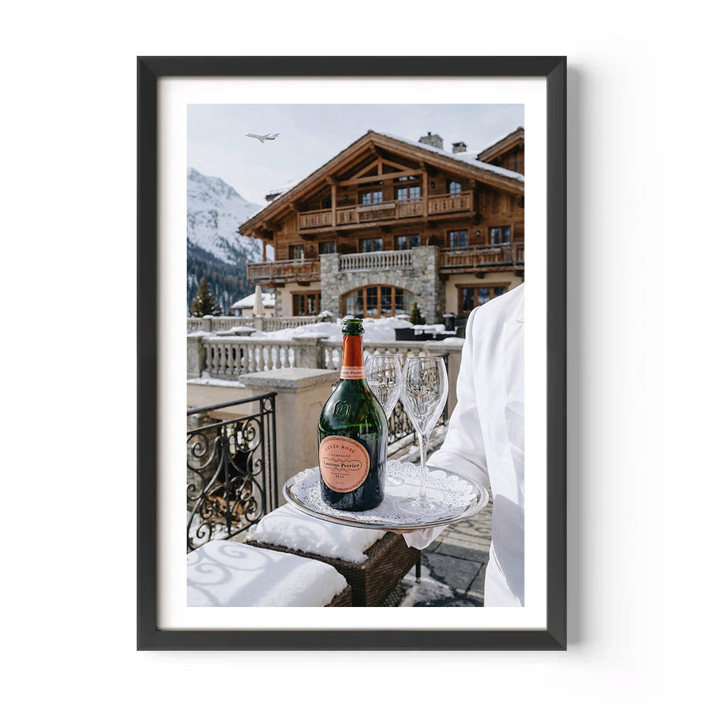Framed print of a snowy balcony scene with a bottle of champagne and glasses.