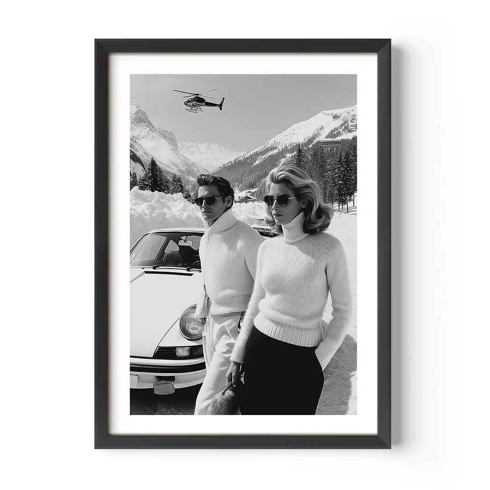 Framed black and white photo of a couple by a car with a helicopter in the background