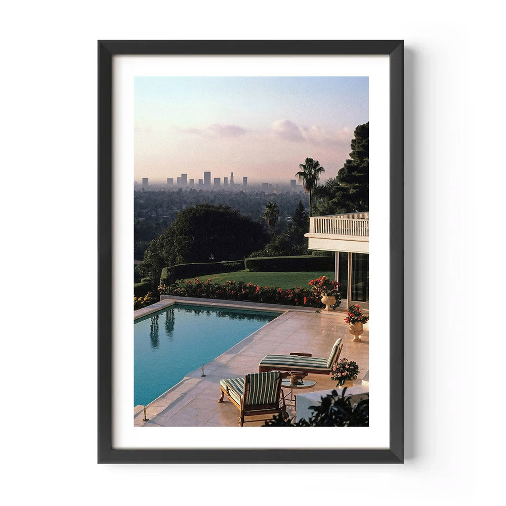Framed artwork of a poolside scene with Los Angeles skyline in the background