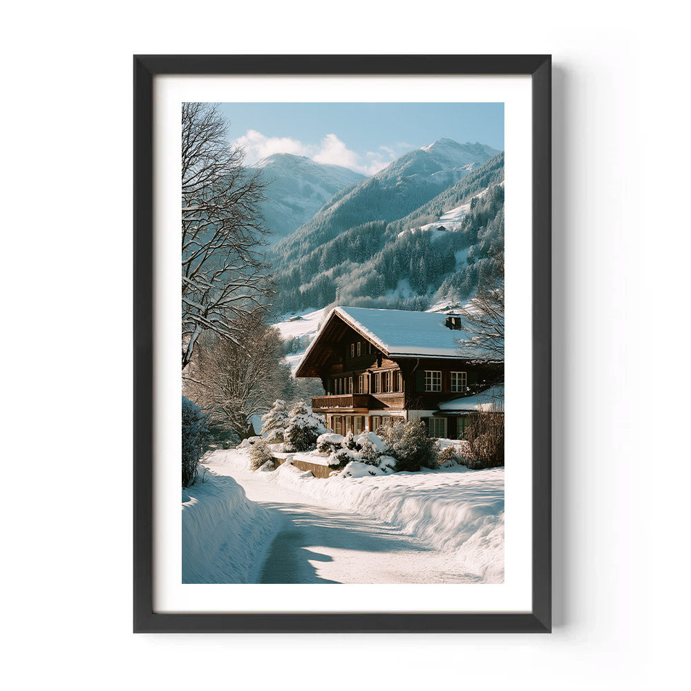 Framed print of a snowy mountain landscape with a wooden cabin.