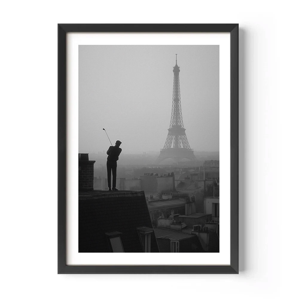 Framed black and white artwork of a person on a rooftop with the Eiffel Tower in the background.