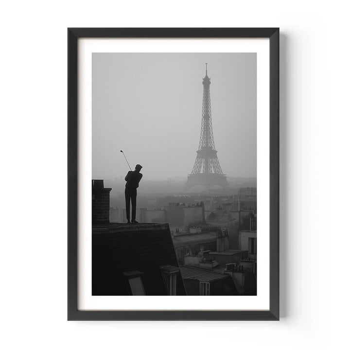 Framed black and white artwork of a person on a rooftop with the Eiffel Tower in the background.