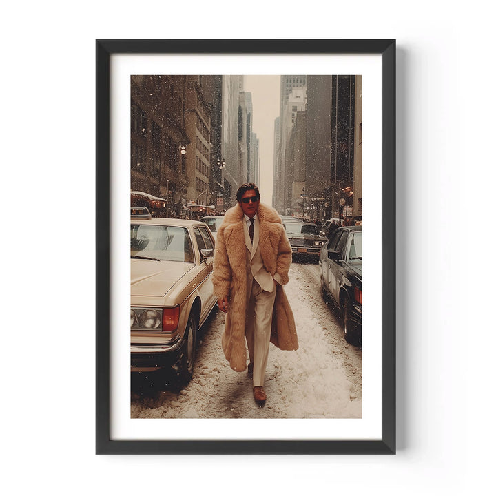Man in a long coat walking down a snowy city street with cars and buildings in the background.