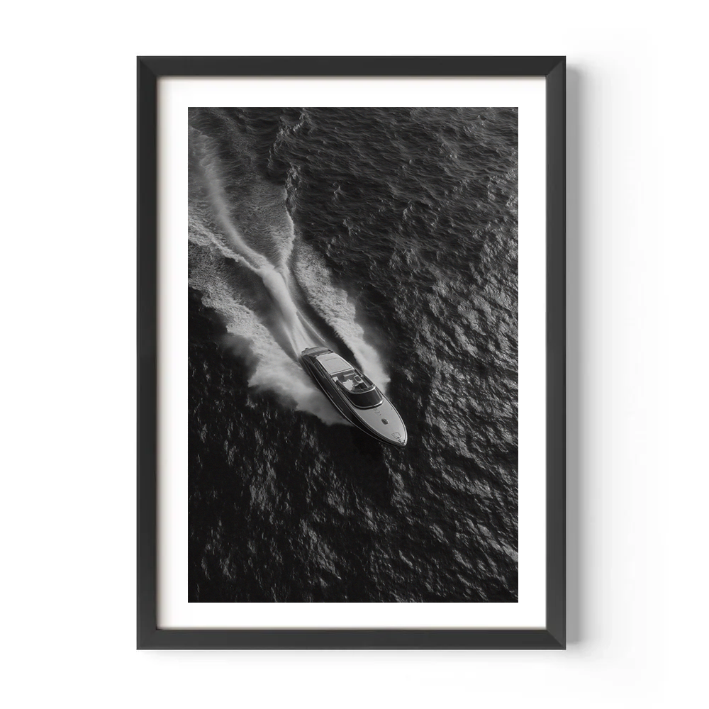 Framed black and white photograph of a speedboat on water