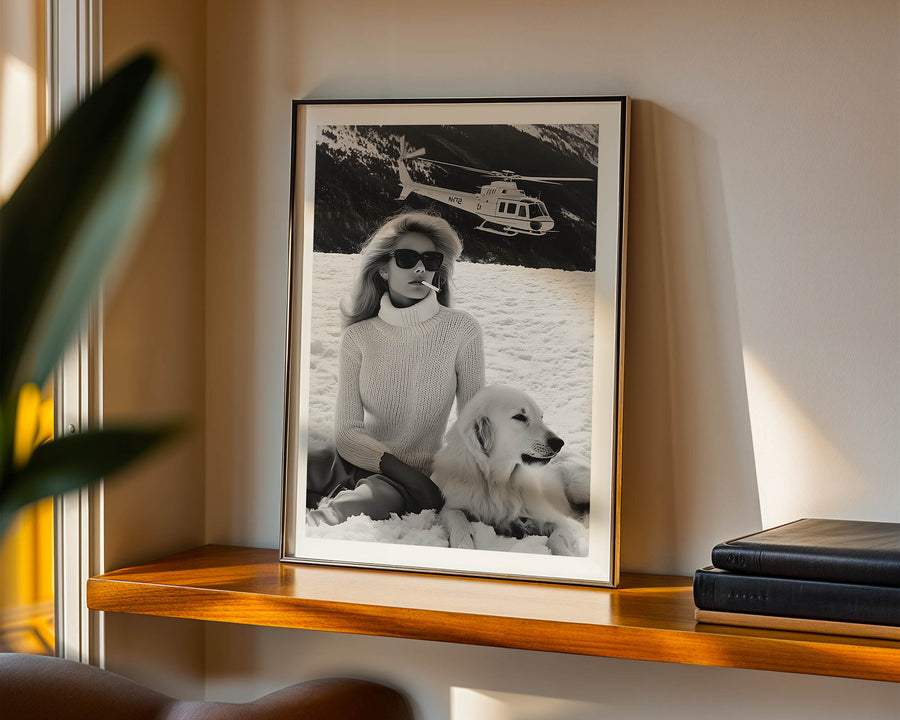 Framed black and white photo of a woman with a dog on a shelf.
