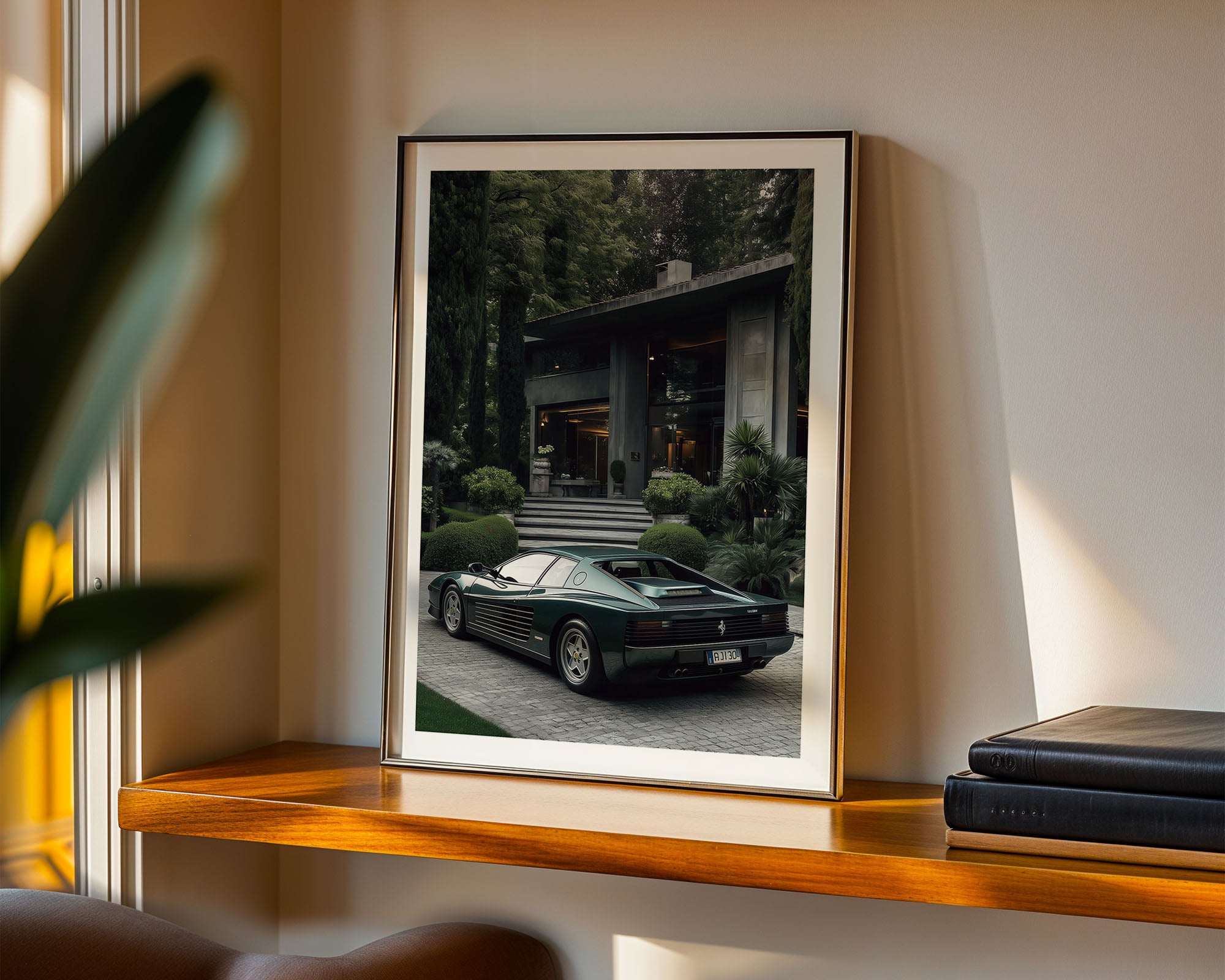 Framed photograph of a green sports car on a shelf with books and a plant.