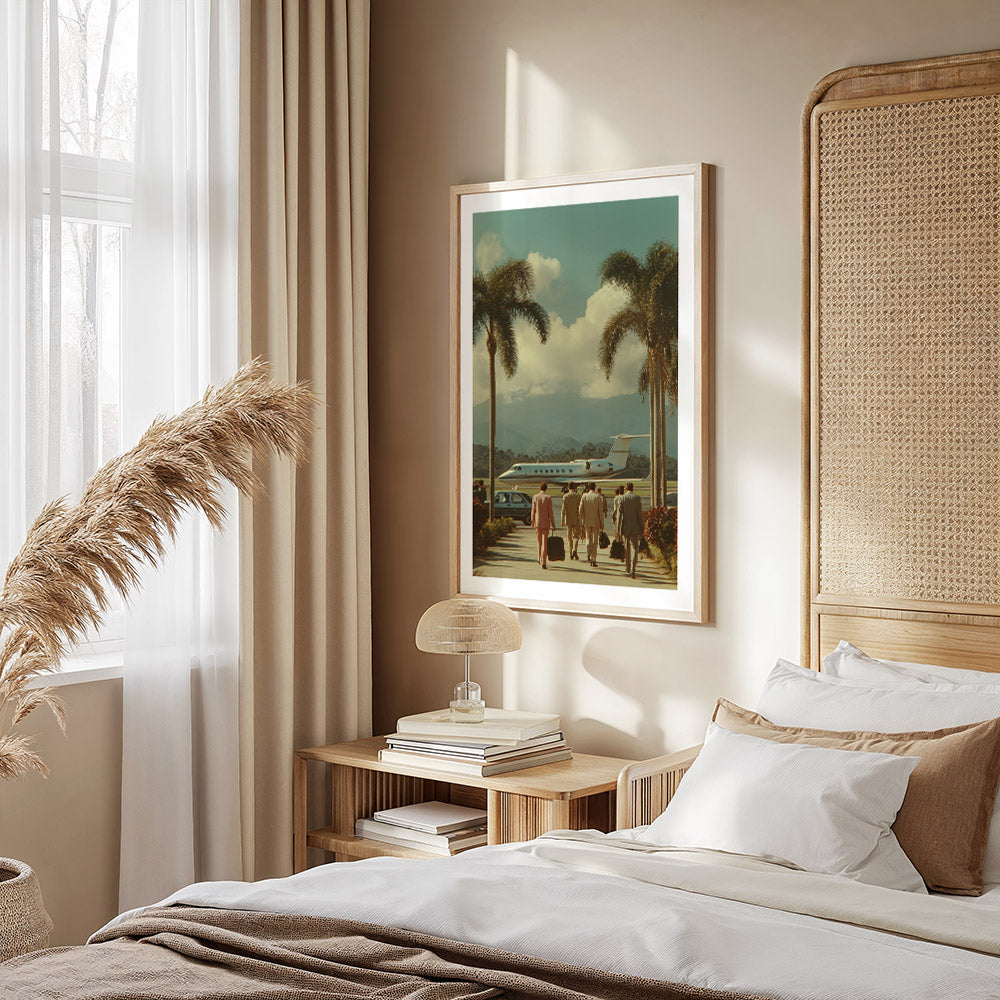 Neatly made bed with white bedding and brown throw, nightstand with books and lamp, framed artwork on wall.