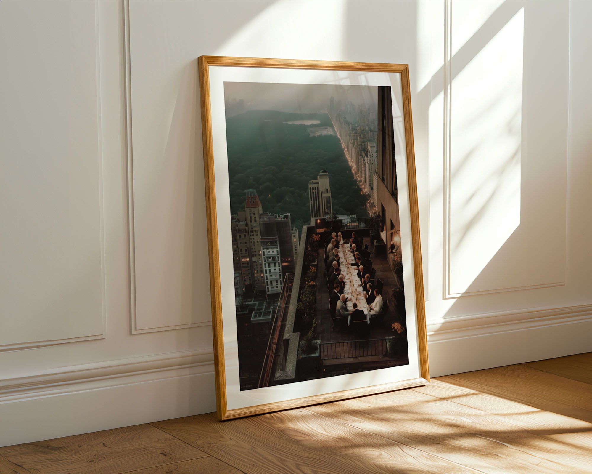 Framed photograph of a cityscape with a long table on a balcony with view over Central Park NYC.