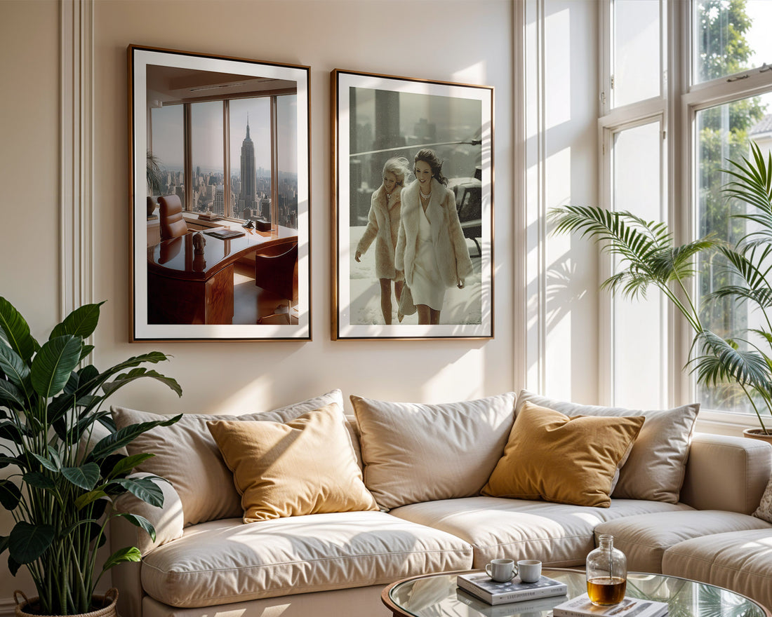 Living room with a beige sofa, framed pictures of New York on the wall, and a large window.