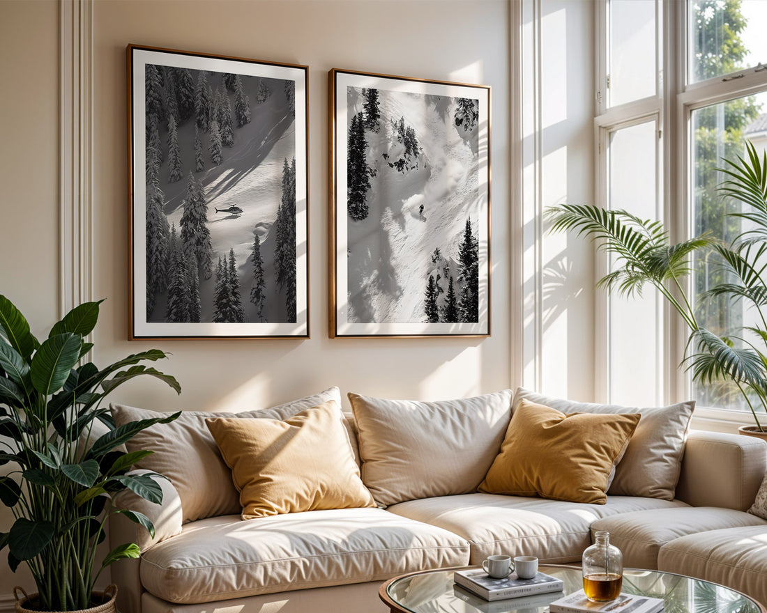 Living room with a beige sofa, decorative pillows, and framed landscape art on the wall.