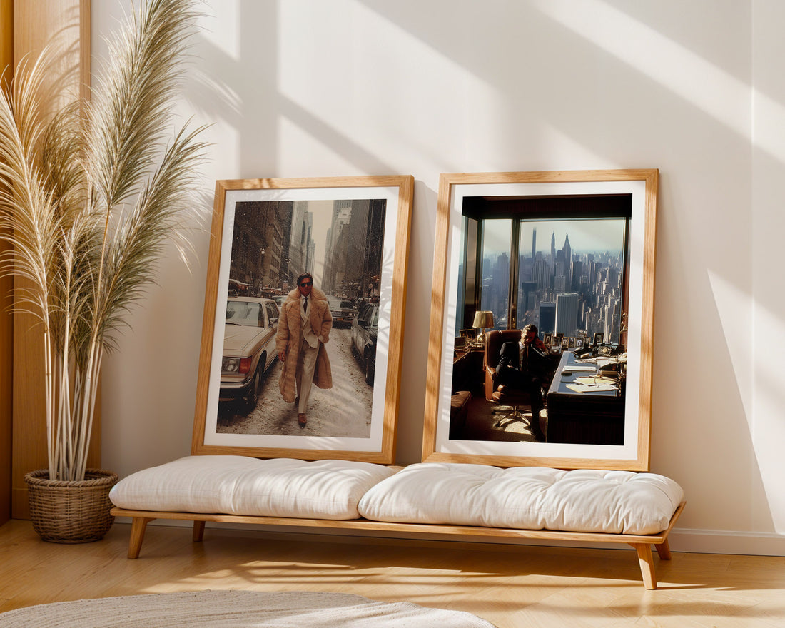 Two framed photographs on a wooden bench with a plant and cityscape view in the background