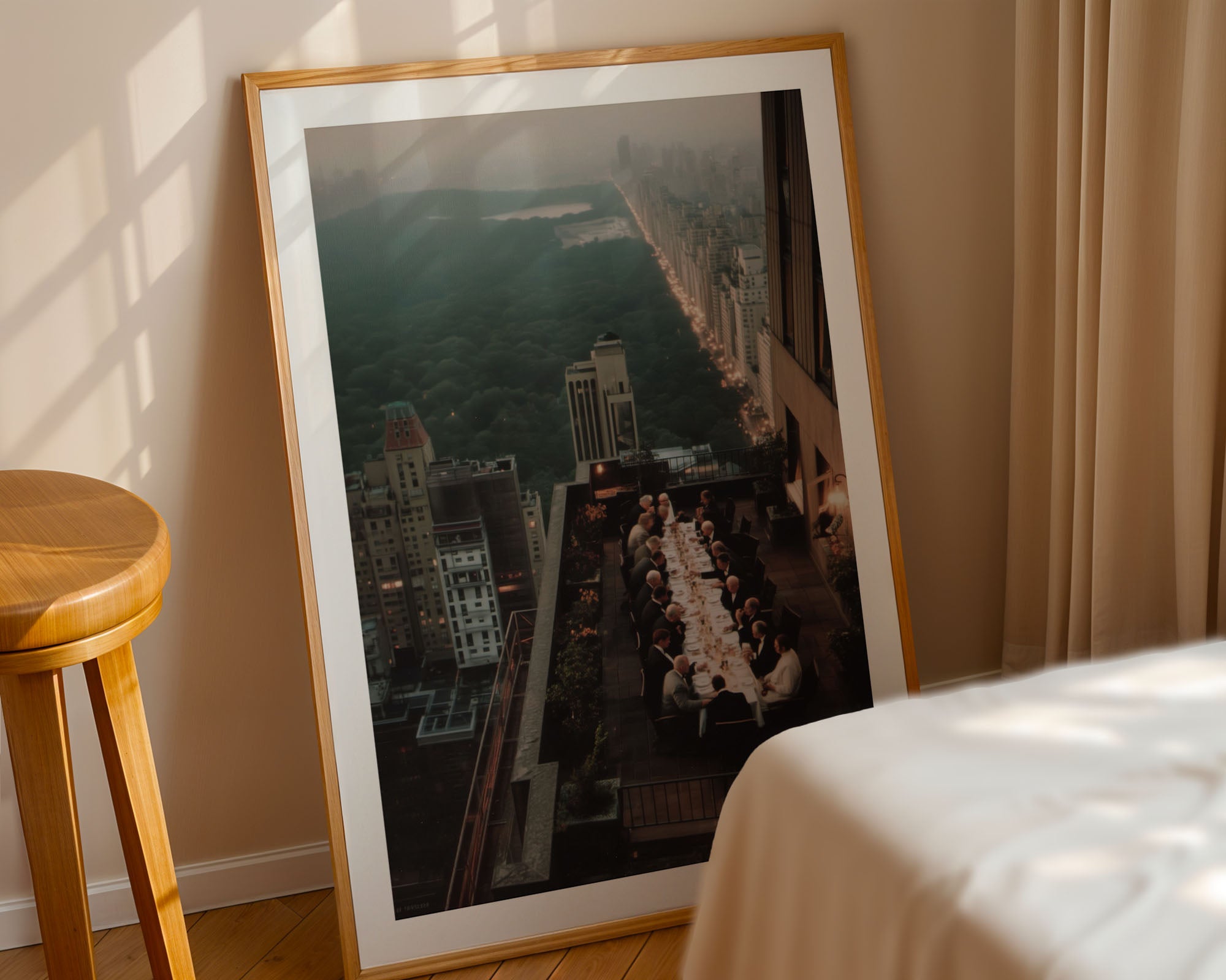 Framed photograph of a cityscape with a long table in an outdoor setting in New York