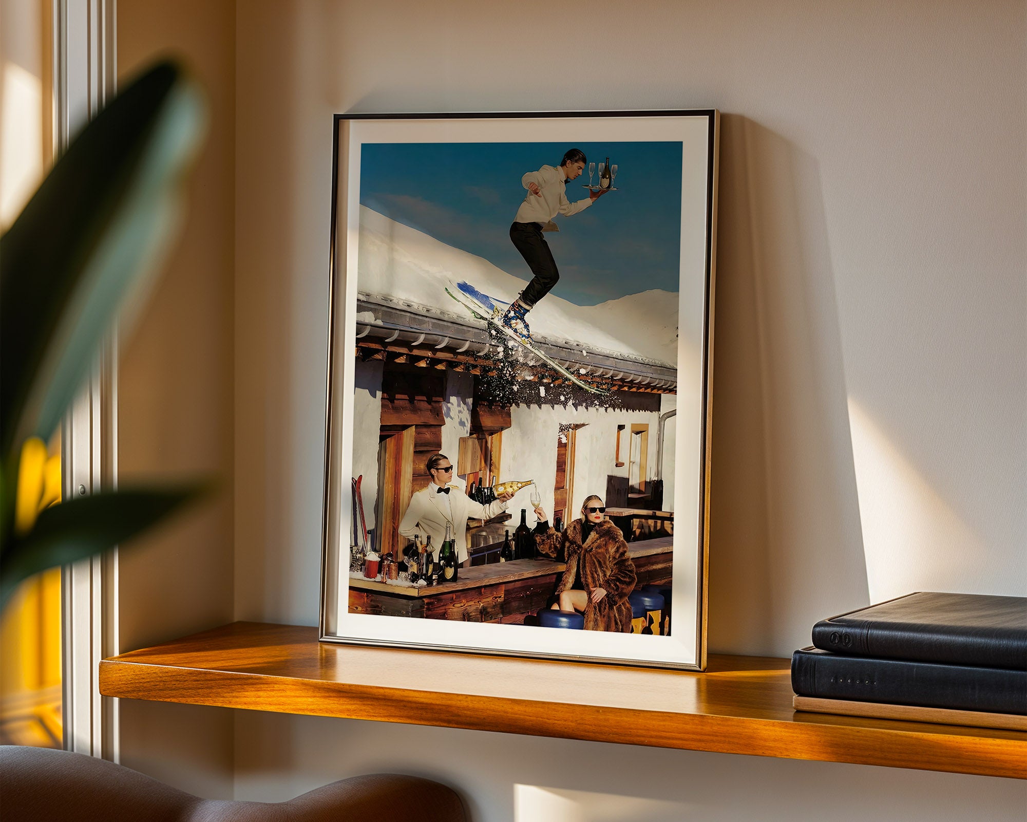 Framed photograph of a person skiing in the Swiss alps on a wall above a shelf.