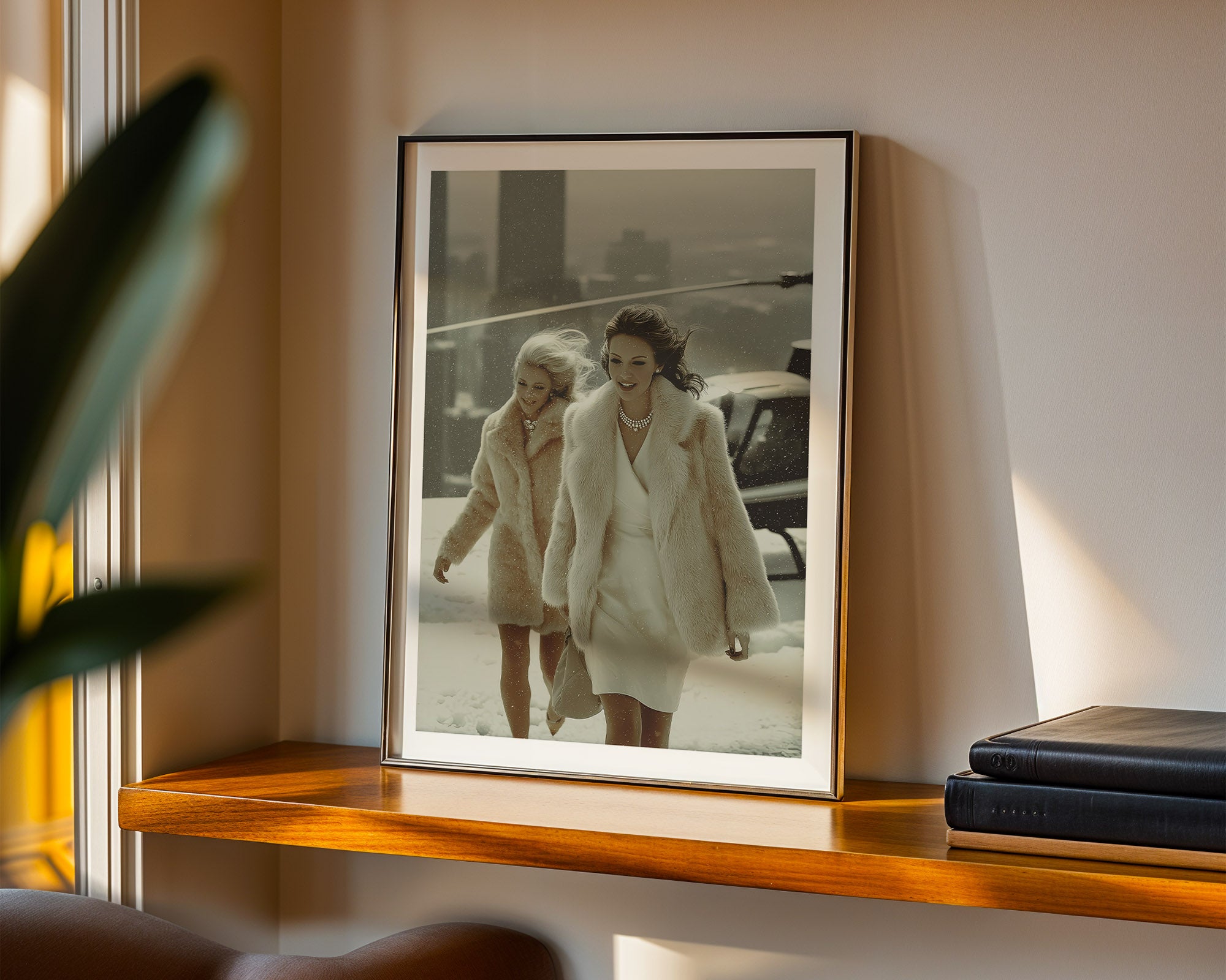 Framed photograph of two women walking on the roof of a skyscraper, displayed on a wooden shelf.