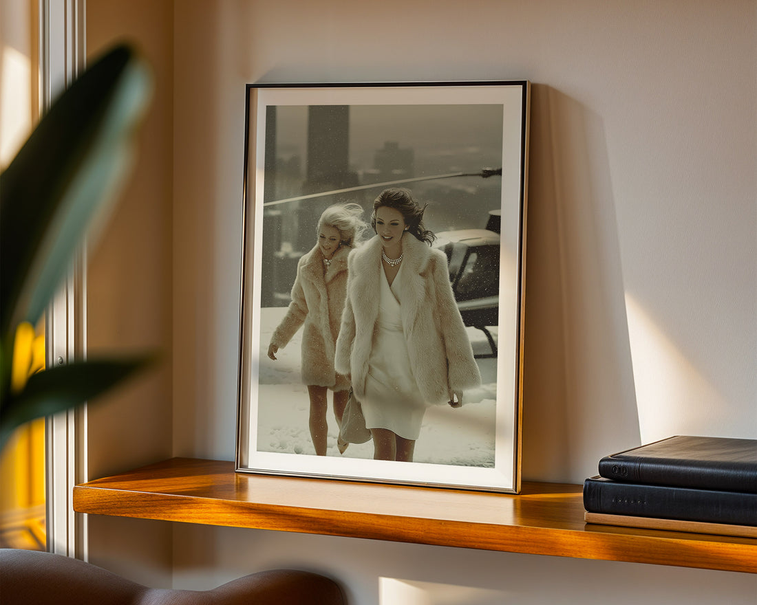 Framed photograph of two women walking on the roof of a skyscraper, displayed on a wooden shelf.