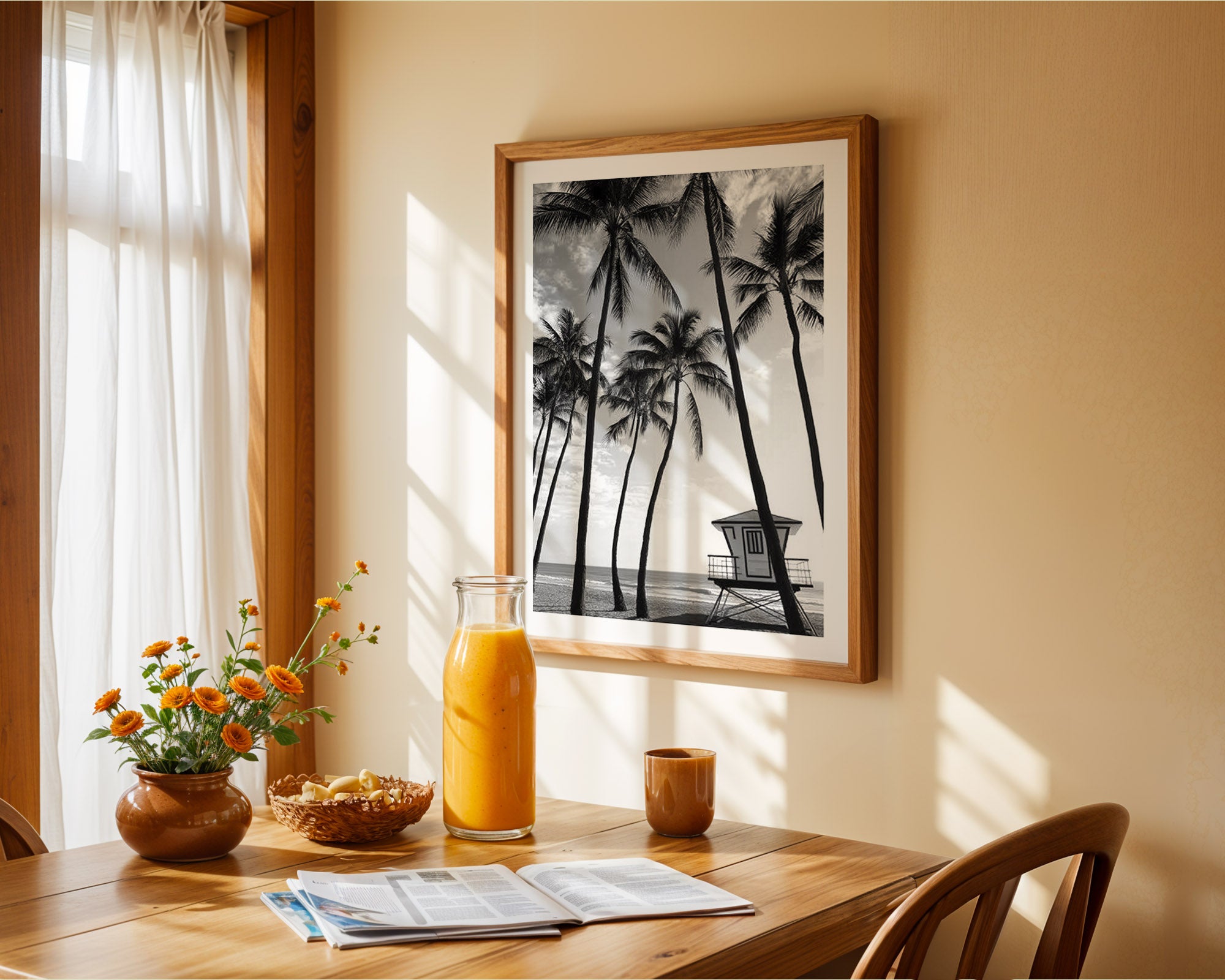 Dining room with a table set for breakfast, including a glass of orange juice, flowers, and a newspaper. A framed black and white palm tree print is on the wall.