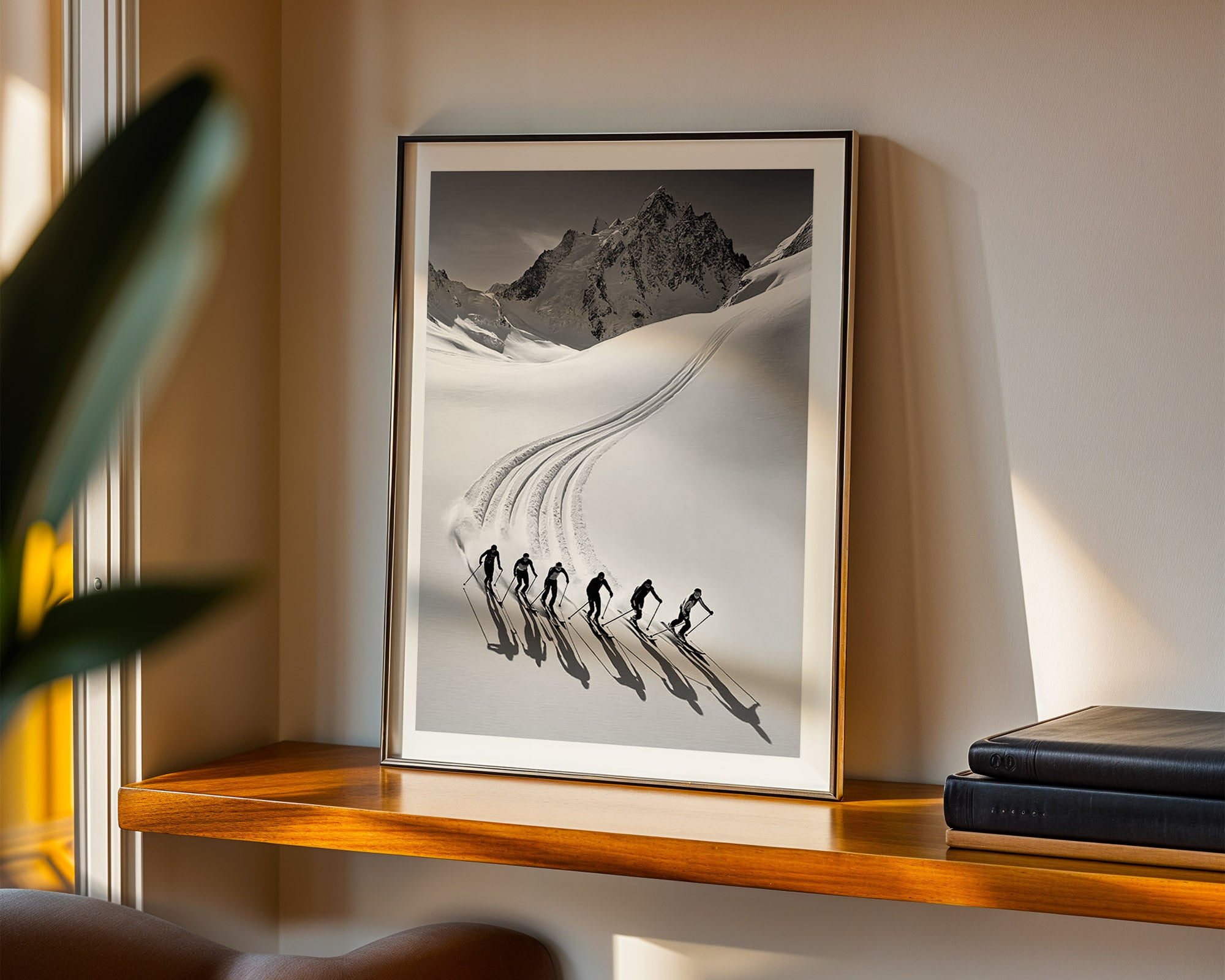 Framed photograph of skiers in a snowy landscape on a wooden shelf.