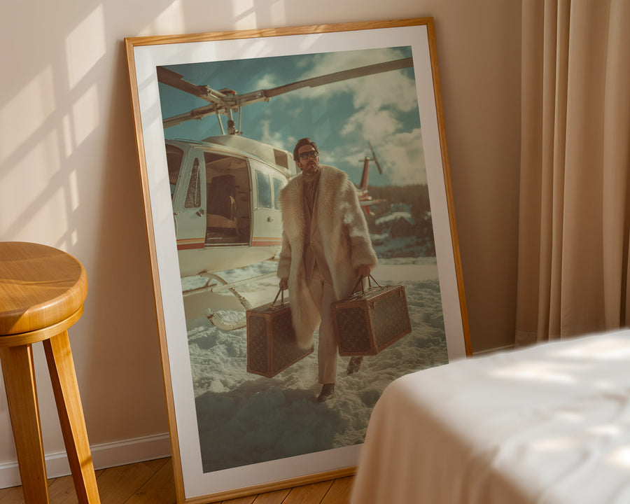 Framed artwork of a person with suitcases on a beach, leaning against a wall.