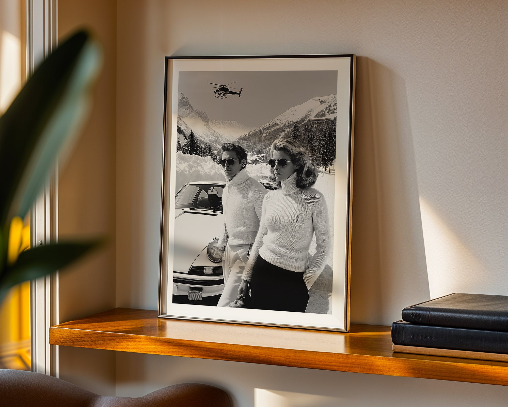 Framed black and white photograph of a couple by a car on a shelf.