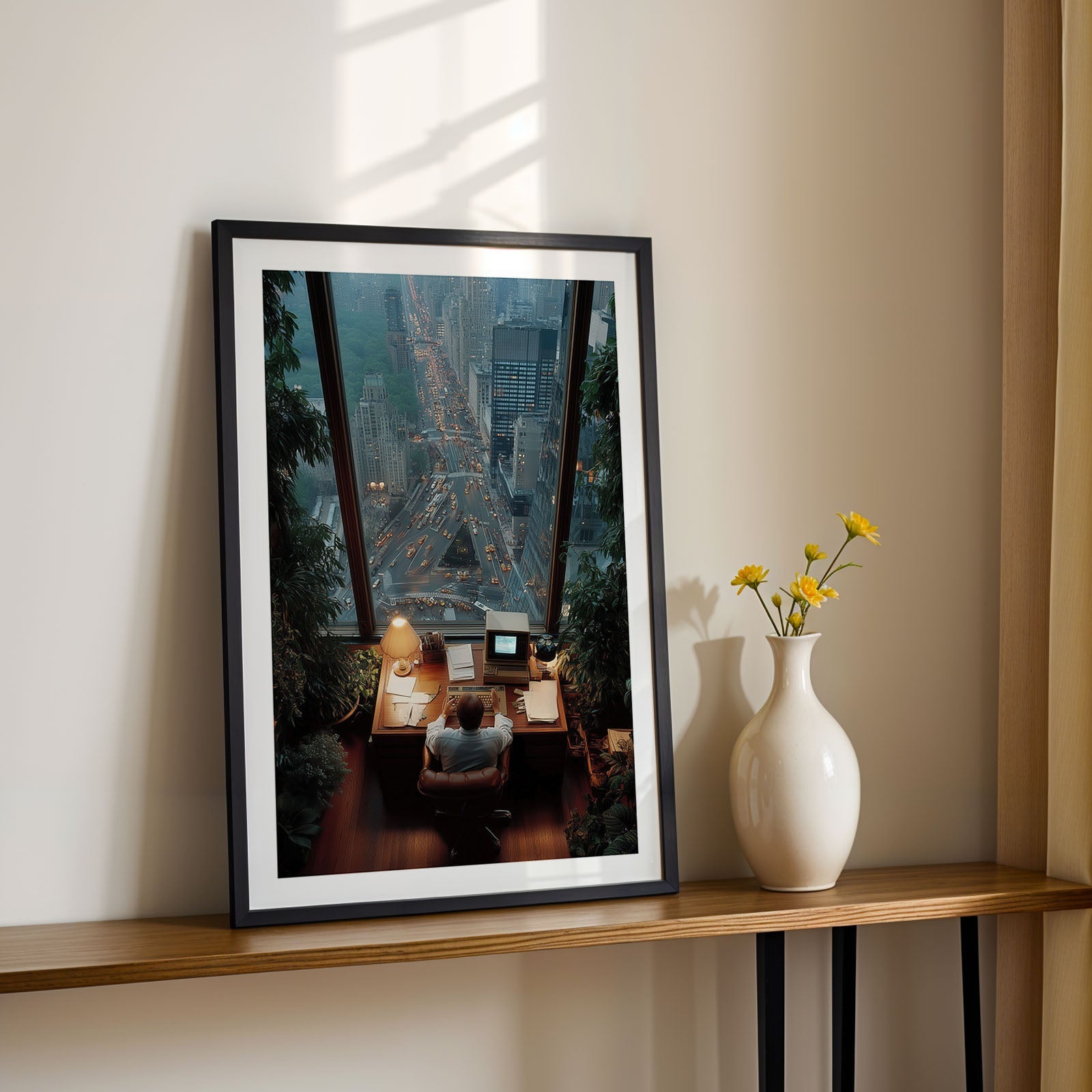 Framed artwork on a shelf with a vase and flowers in a room with sunlight filtering through curtains.