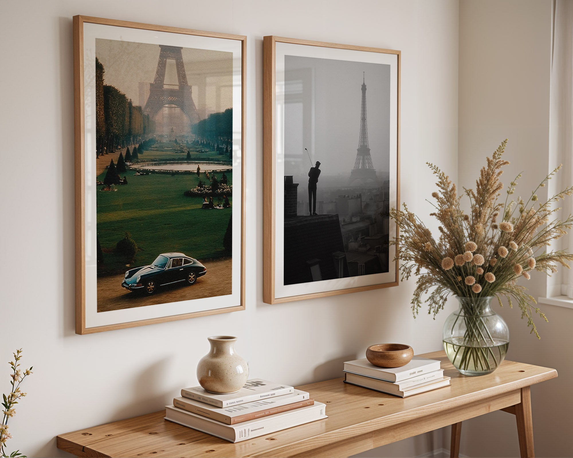 Two framed artworks on a wall above a wooden console table with decorative items.