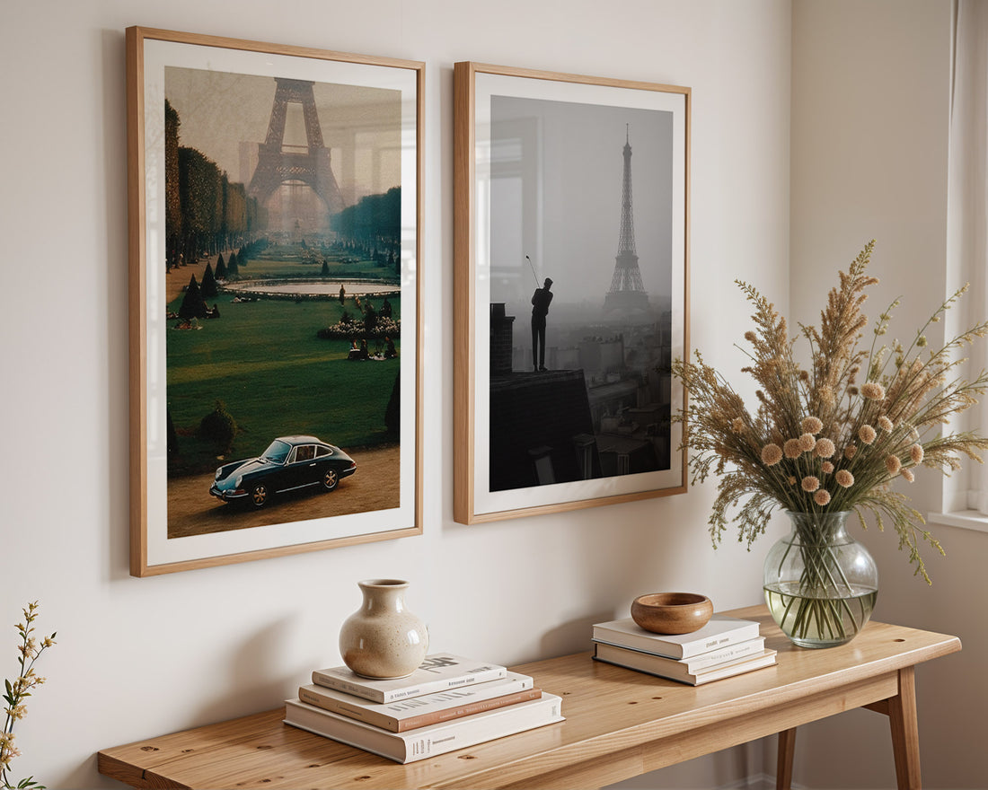 Two framed artworks on a wall above a wooden console table with decorative items.