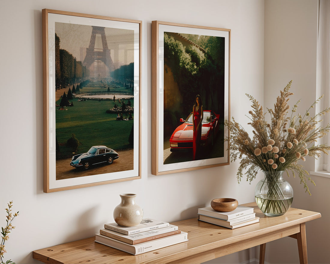 Two framed artworks on a wall above a wooden console table with decorative items.