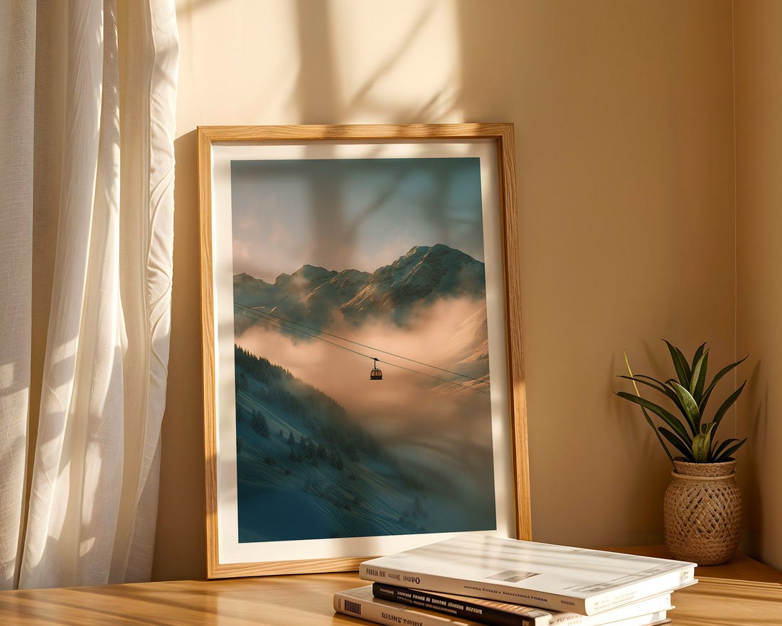 Framed mountain landscape print on a shelf with books and a plant