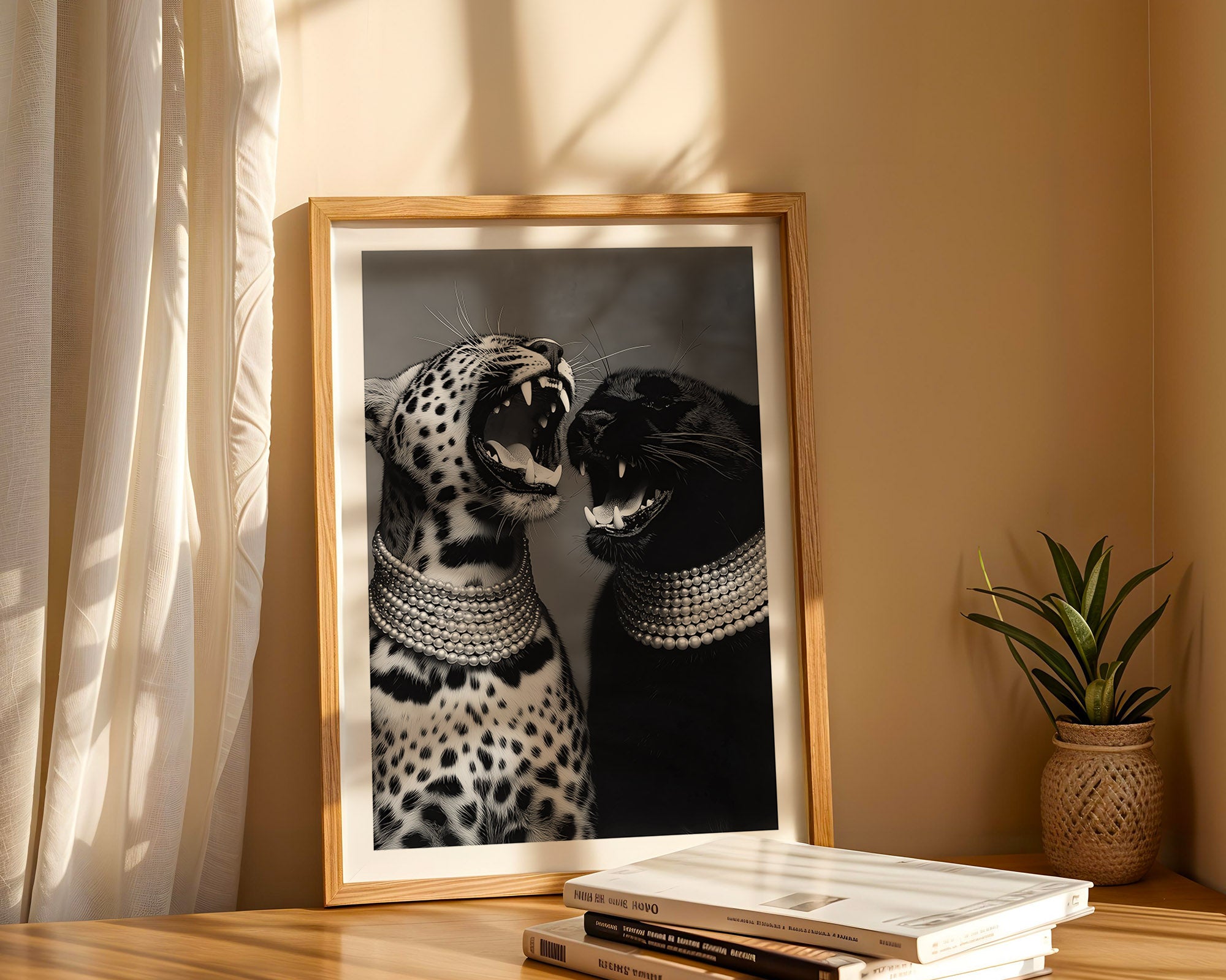 Framed artwork of two cats on a shelf with books and a plant.