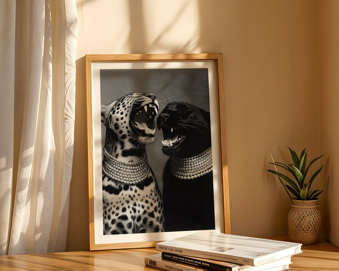 Framed artwork of two cats on a shelf with books and a plant.