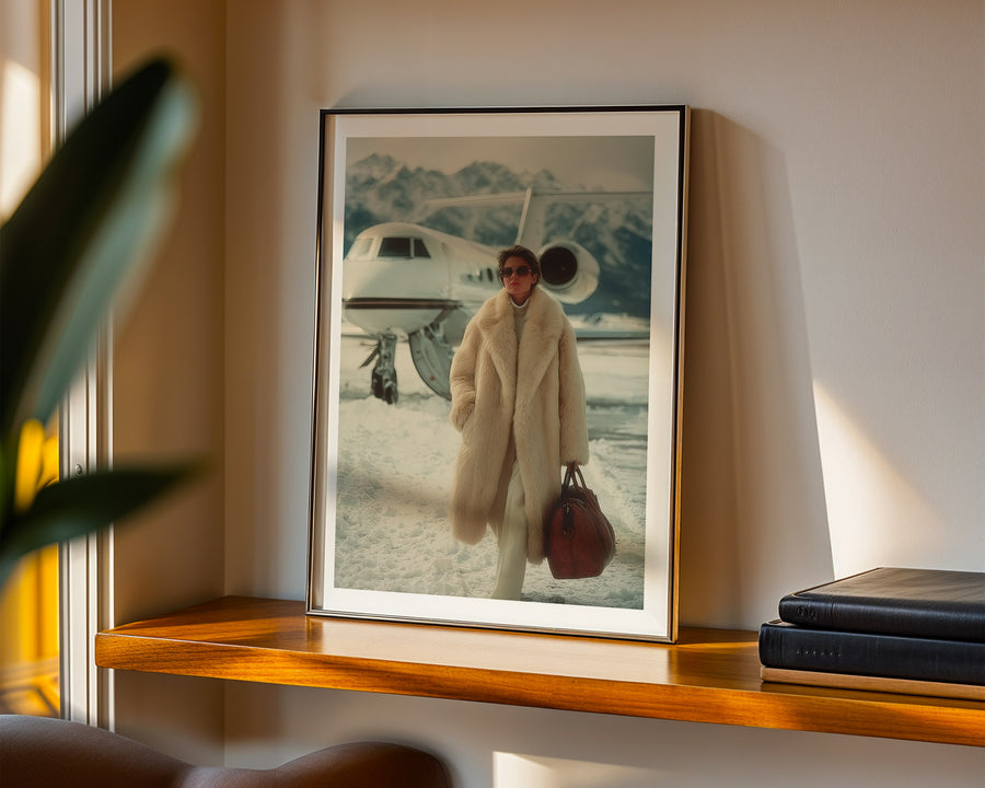 Framed artwork of a person in a coat with a suitcase on a shelf.