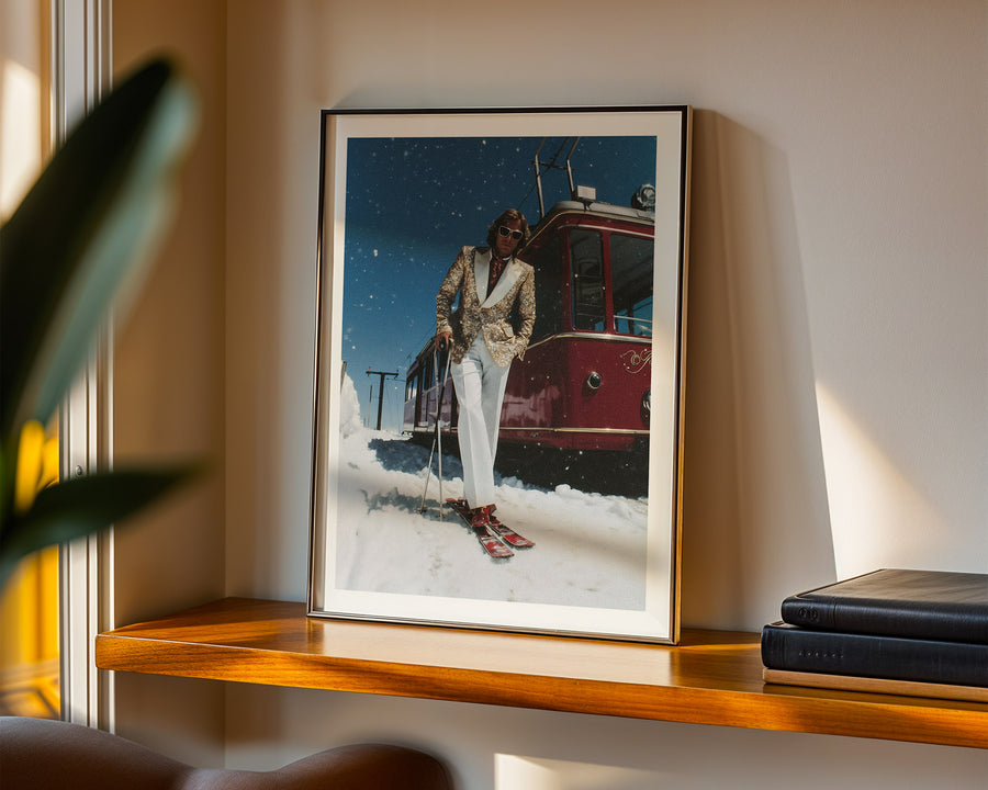 Framed photograph of a person in a snowy landscape with a trolley in the background, displayed on a shelf.