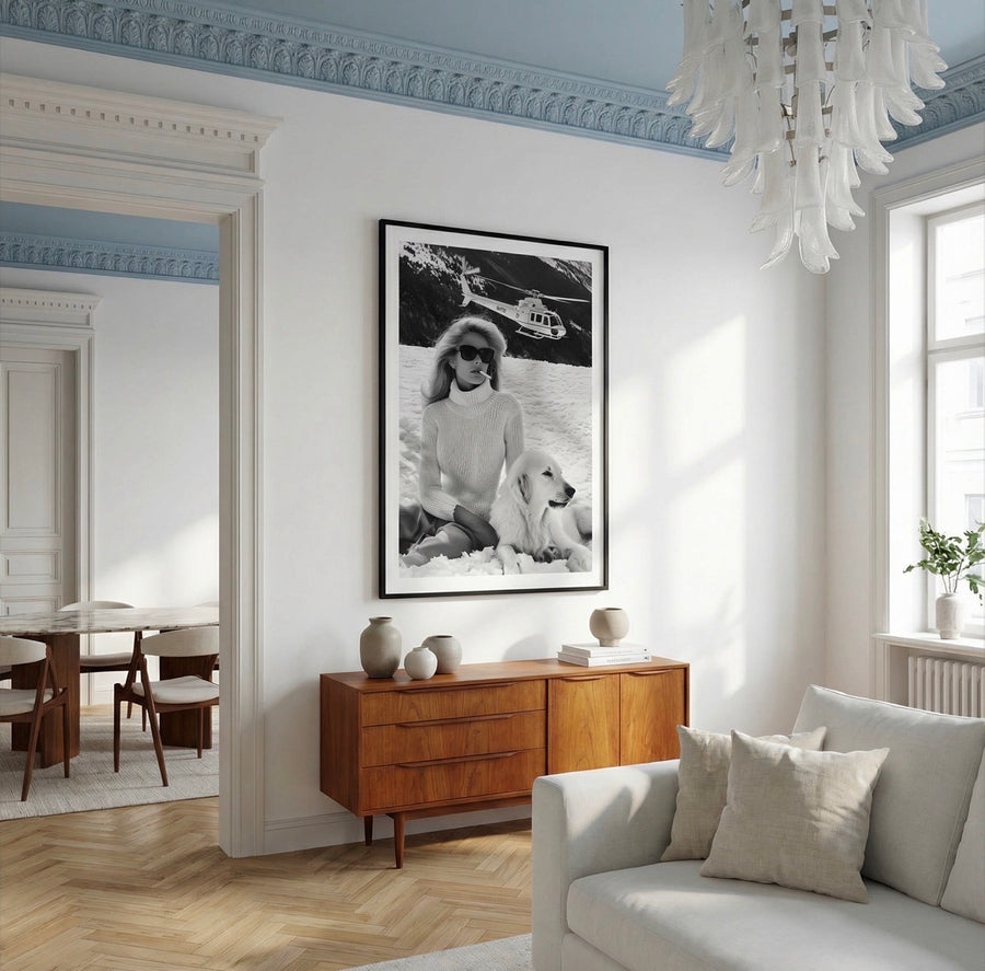 Living room with a wooden sideboard, white sofa, and framed picture on the wall.