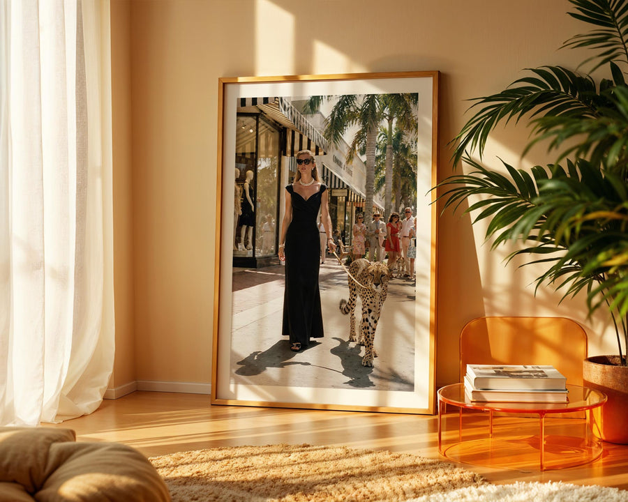 Framed photograph of a woman in a black dress with a leopard in a living room.