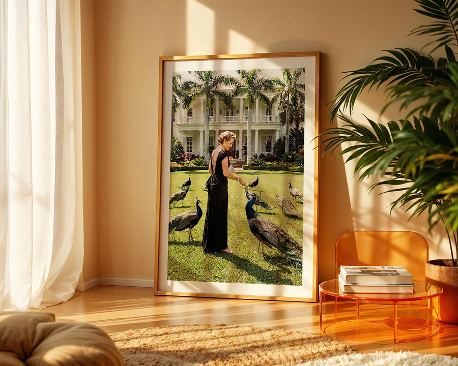 Framed artwork of a woman with peacocks in a living room setting.