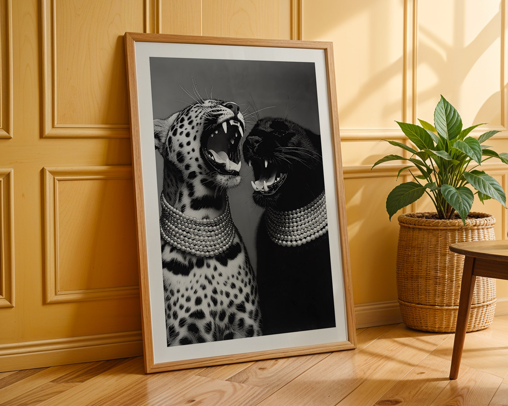 Framed artwork of two leopards with decorative collars on a wooden floor.