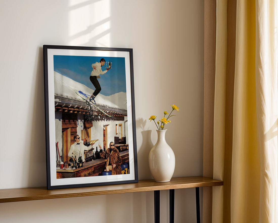 Framed photograph of a Swiss Apres ski on a shelf with a vase and flowers