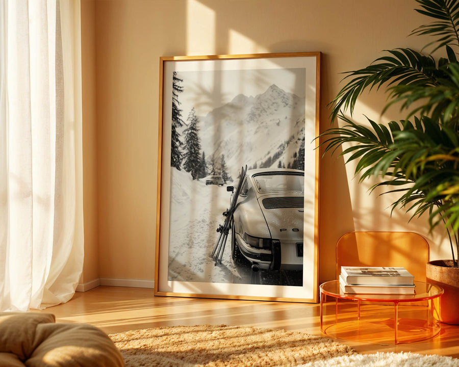 Framed artwork of a snowy landscape with a porsche 911 in a living room.