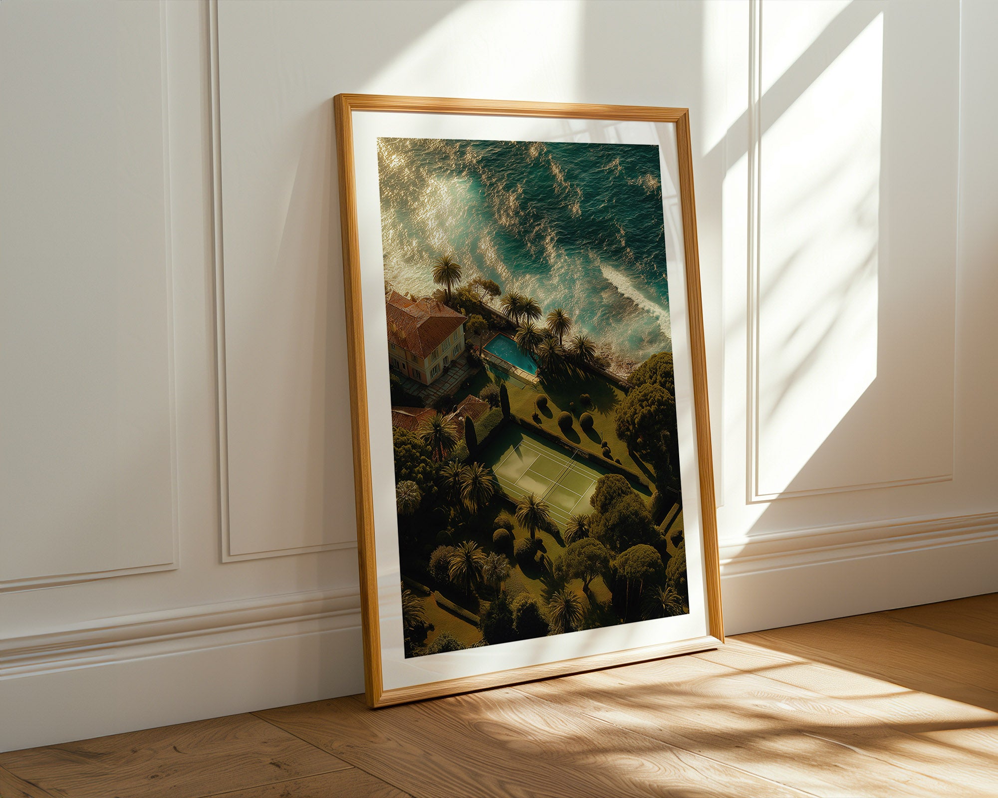 Framed artwork on a wall with sunlight casting shadows